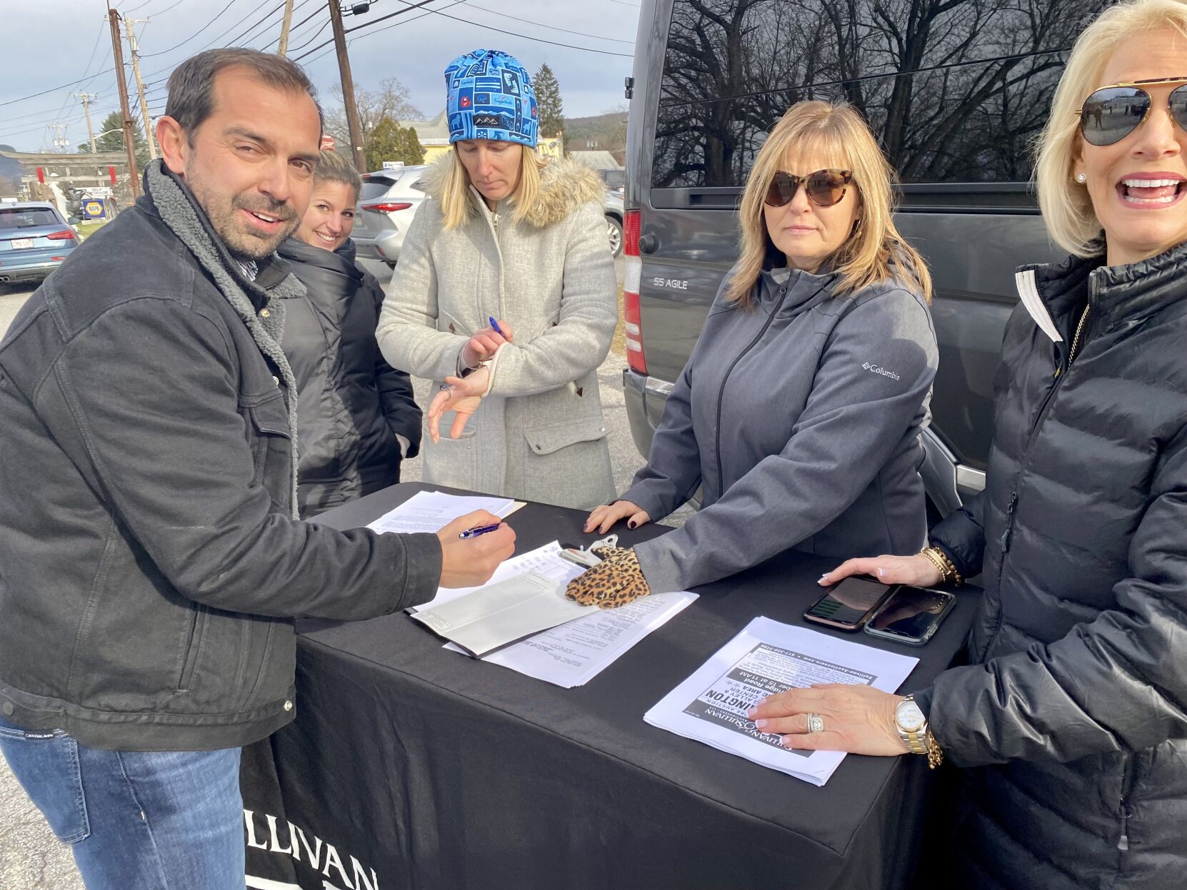 Craig Barnum signs paperwork